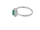 side A classic cluster ring set with an oval cut emerald centre stone, measures 6x4mm, grass green colour.

Complimented by an outer halo of twelve brilliant cut white diamonds, each 1.7mm (total est at 0.25 carats)