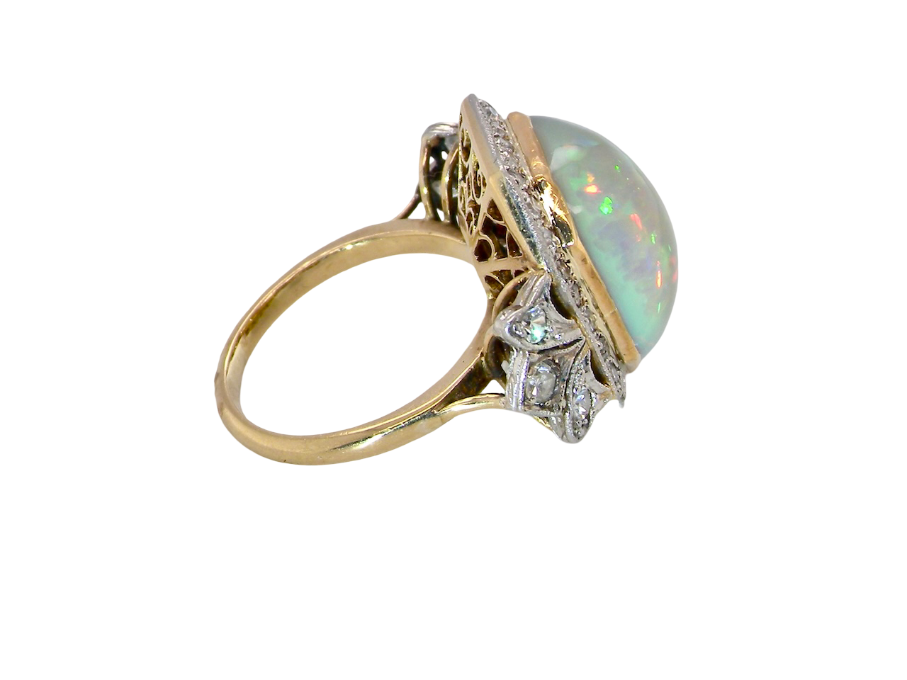 side cabouchon cut opal shown is cushion shaped, measures 15x13 (5.78 carats) displaying a mass of vibrant colours, from flashes of fireglow orange, luminous greens, and lavender purples.
