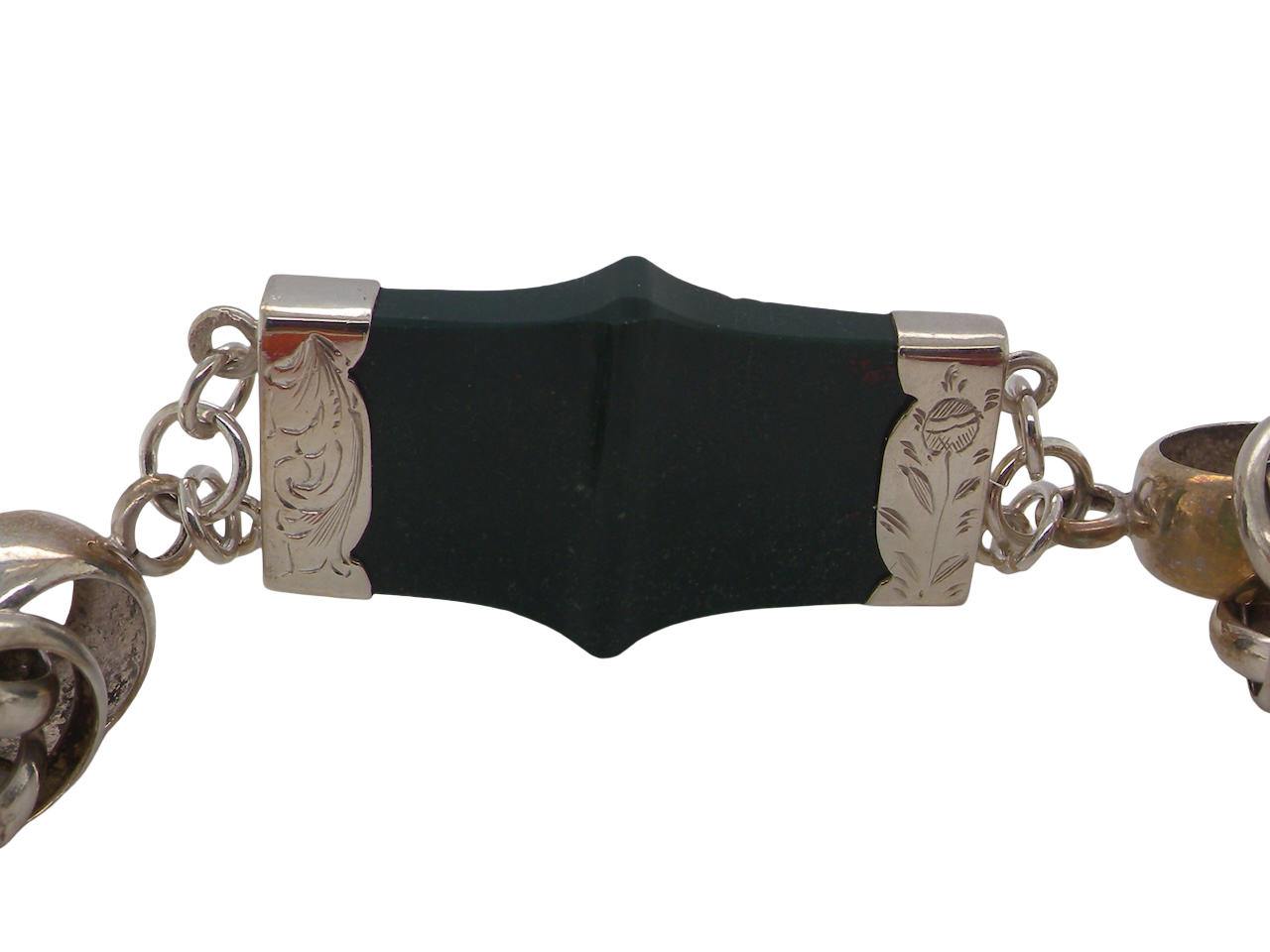 sterling silver bracelet of Scottish origin, featuring a panel of bold, shaped links. Each panel link 