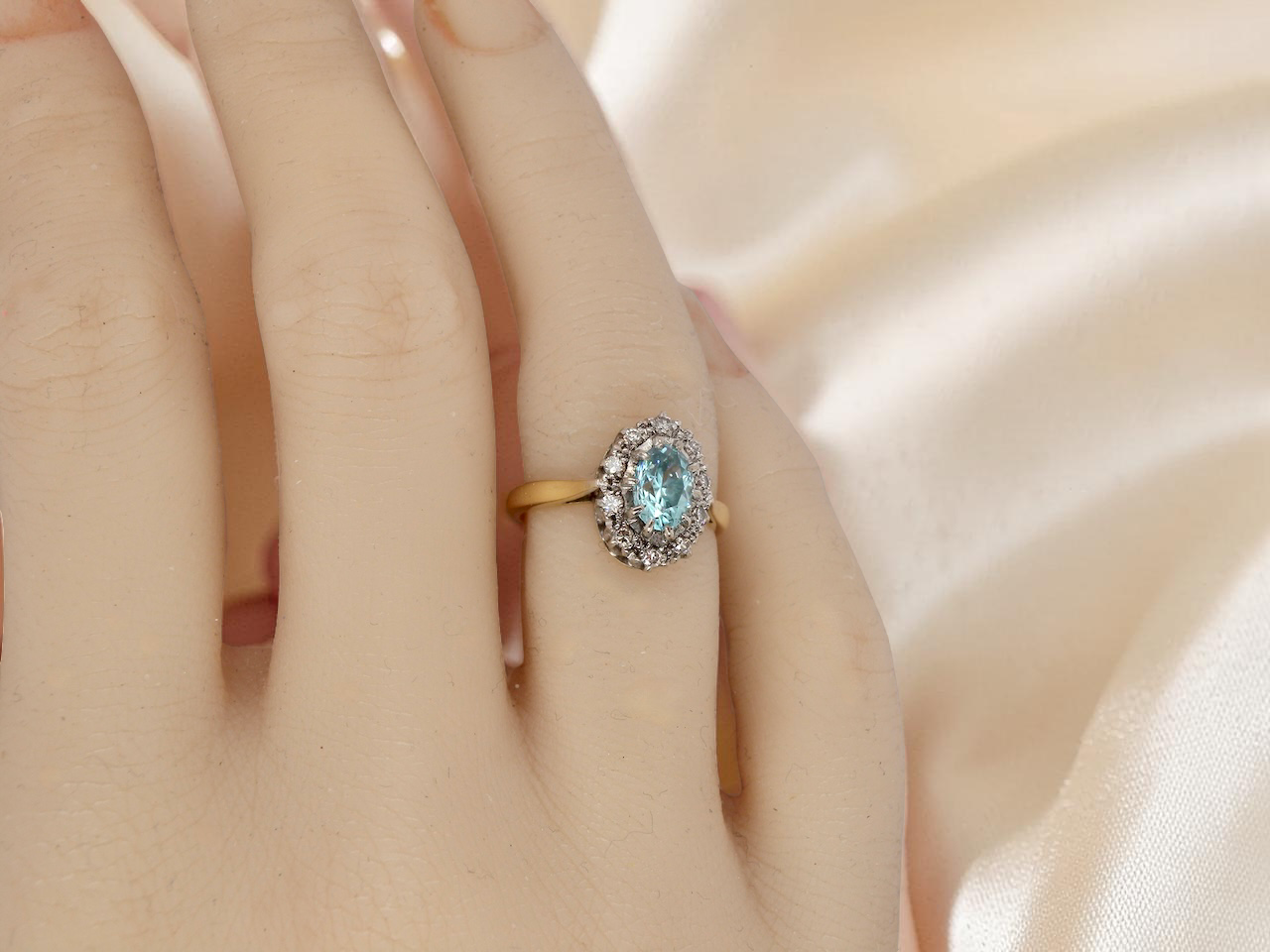 tape A cluster ring set with a natural blue zircon centre stone, 7.5x5mm, vibrant aquamarine colour.&nbsp;
