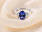 top A three stone ring that features an impressive tanzanite centre stone that measures 10x8mm (3.21 carats confirmed) AAA colour.&nbsp;
