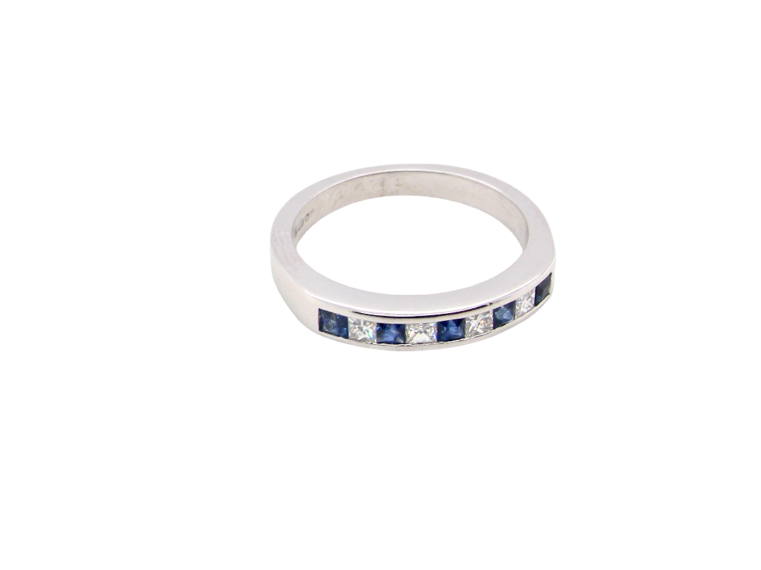 top An 18 carat white gold half hoop eternity ring. Set with princess cut white diamonds, total of four- estimated 0.40 carats (2.4mm each) colour H-j, clarity Si.