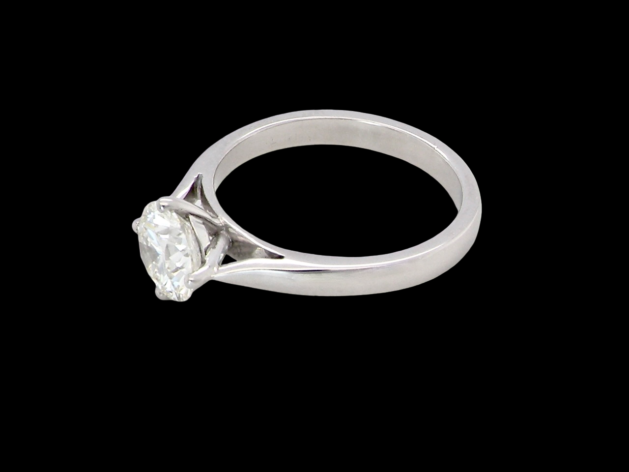 top An impressive platinum solitaire ring set with a modern brilliant-cut white diamond.