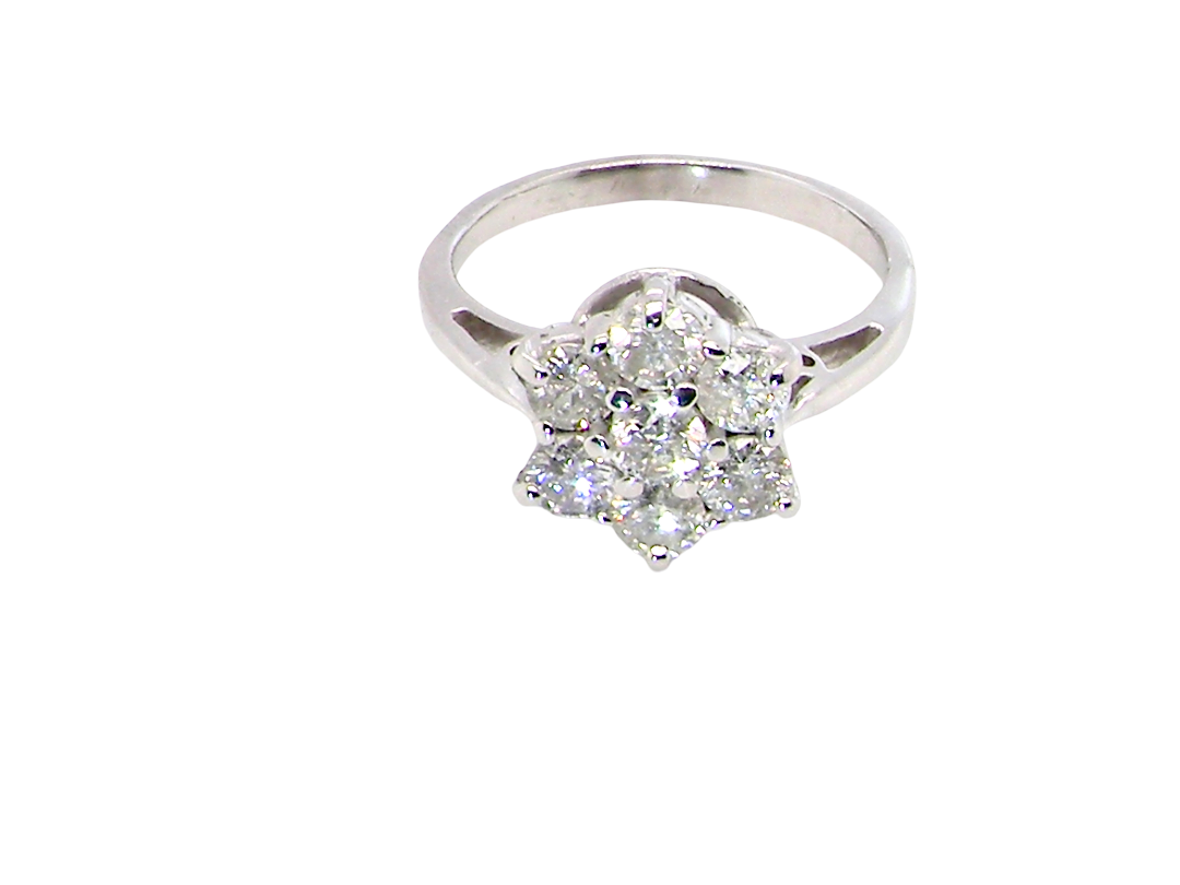 top view A beautiful vintage diamond cluster ring, elegantly set with seven brilliant-cut white diamonds in a timeless floral cluster design.