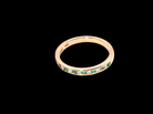 top view A brand new half hoop eternity ring. Set with eight 1.3mm emeralds (total 0.12 carats) and interspaced with brilliant cut white diamonds, each 1.3mm (0.10 carats)