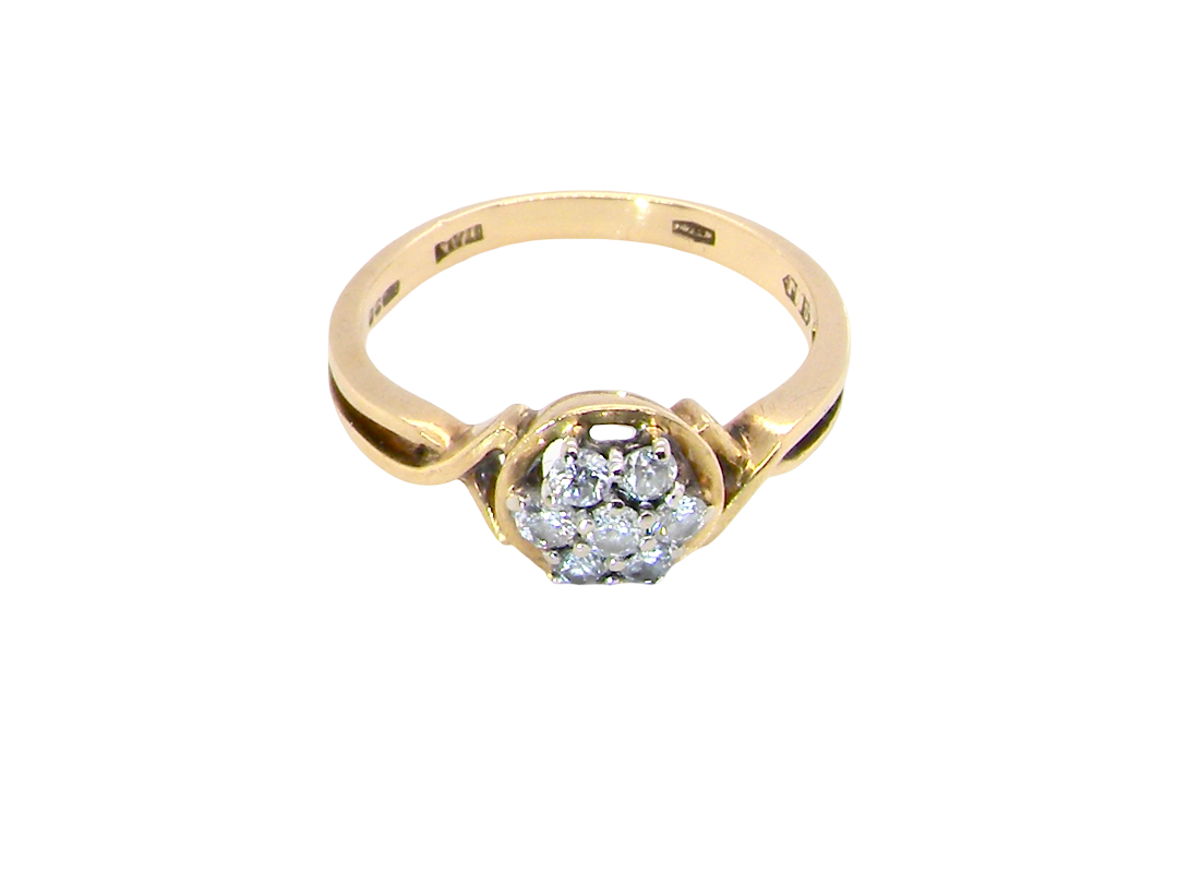 top view A classic 1980s cluster ring. Seven brilliant cut white diamonds , each 2.5mm (est 0.40 carats). Colour i-j, clarity Si. Claw set in white gold.