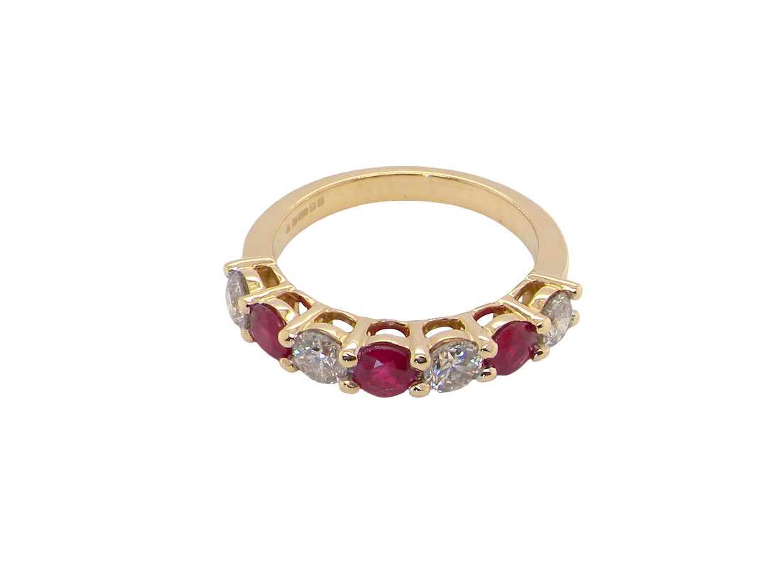 top view A fine half hoop ring. 18 carat gold set with three rubies, each 3.8mm (est 0.20 carats, total 0.67 carats) and four brilliant cut white diamonds, each 3.8mm (total 0.85 carats)&nbsp;
