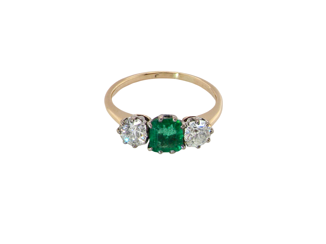 top view A vintage trilogy ring. Centre stone a step cut emerald, 6.5x5.5mm (est .75 carats). The emerald is dark green. 