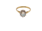 top view An elegant&nbsp; cluster ring featuring a white opal centre stone measuring 6 × 4mm, displaying a lively and attractive play of colour.