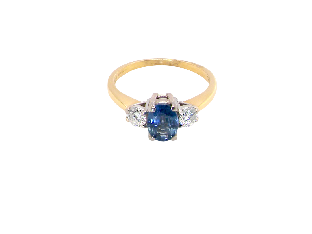top view The iconic trilogy ring, featuring an oval cut sapphire centre stone, with a pleasing mid blue hue set into four claws, 7x5mm (0.75 carats est)