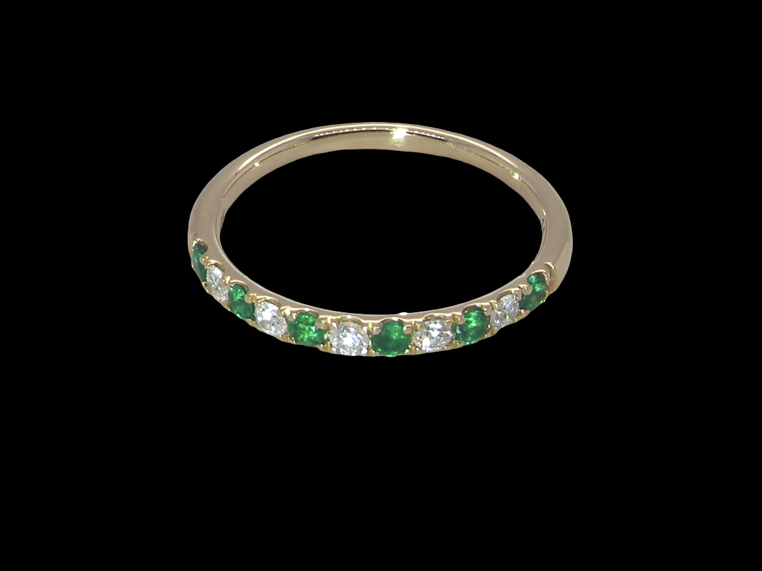 top view This ring is set with six bright green emeralds, each 2mm, (est 0.25 carats) and five 2mm brilliant cut white diamonds.