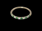 top view This ring is set with six bright green emeralds, each 2mm, (est 0.25 carats) and five 2mm brilliant cut white diamonds.