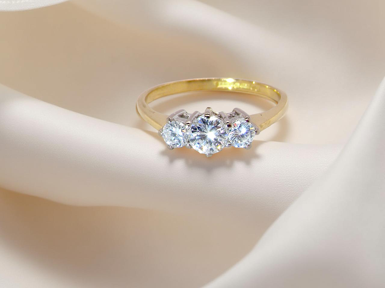 trilogy ring is set with three brilliant-cut white diamonds in a timeless and meaningful design. 