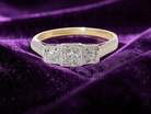 A vintage trilogy ring. Set with three old brilliant cut white diamonds, centre 3mm and each side a 2.4mm diamond. Total estimated at 0.20 carats, colour H-j, clarity Si
