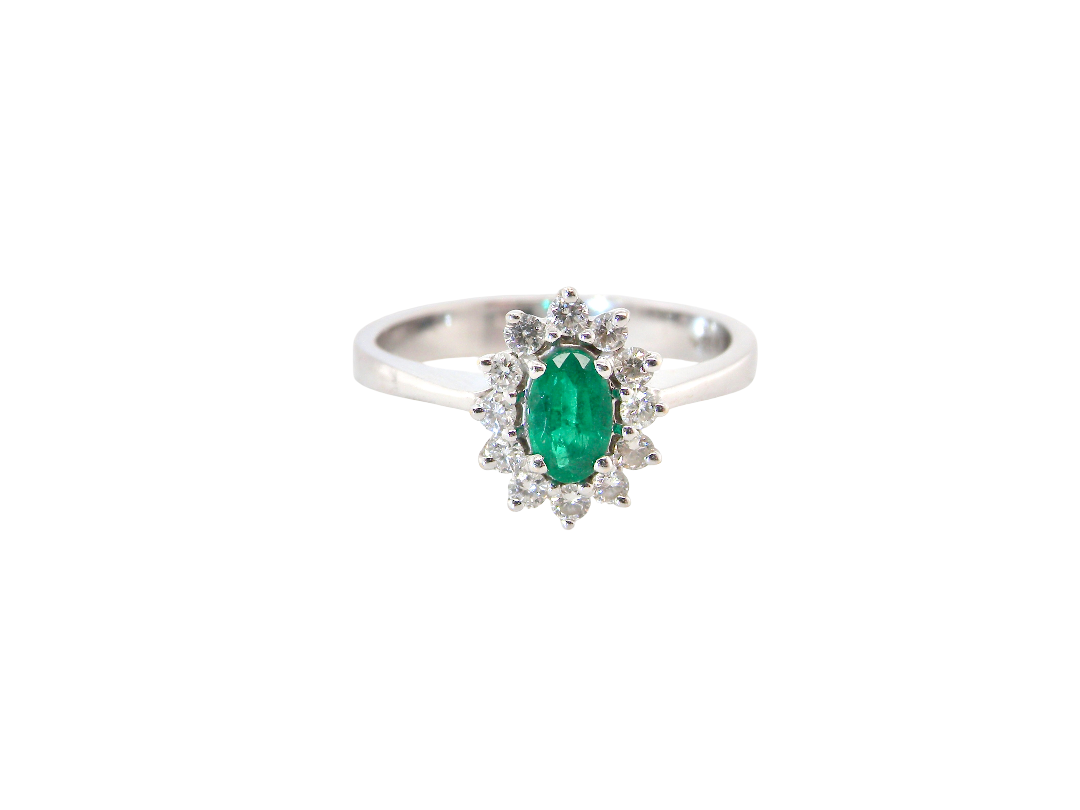 white gold cluster ring.

Centre stone is an oval cut emerald, 6x3.7mm (just under 0.50 carats) 