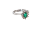 white gold cluster ring.

Centre stone is an oval cut emerald, 6x3.7mm (just under 0.50 carats) good deep green hue. side