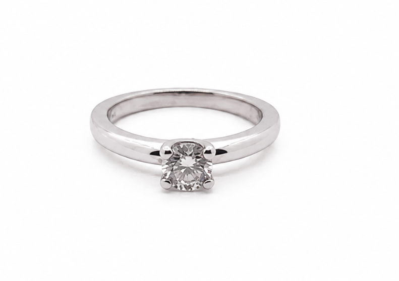 white gold ring with a diamond solitaire on a white background