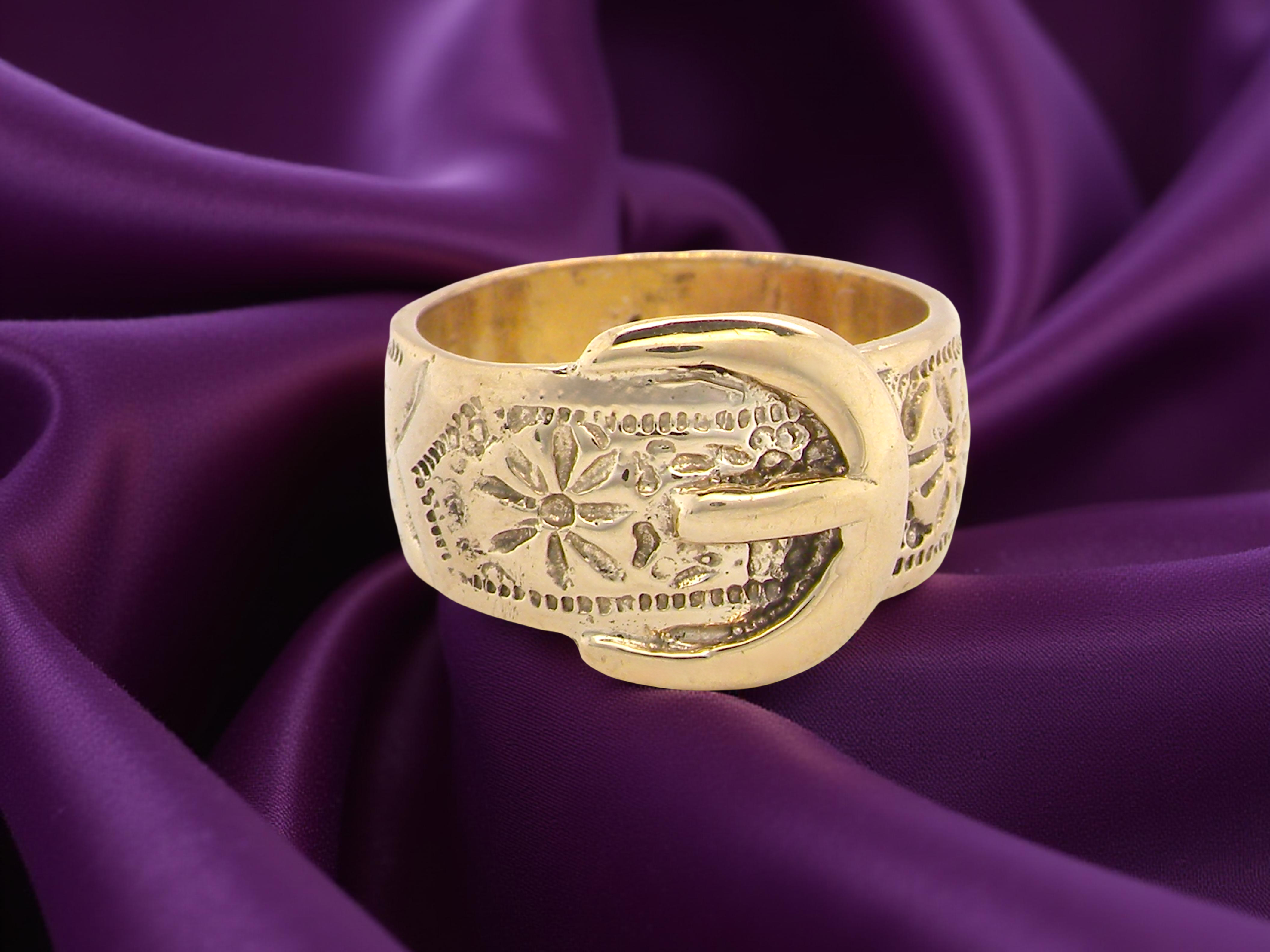 A wide gold buckle ring