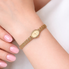 wrist view A 9 carat gold wrist watch by Rotary. Oval dial with a diamond dot at the 12. Champagne coloured dial.