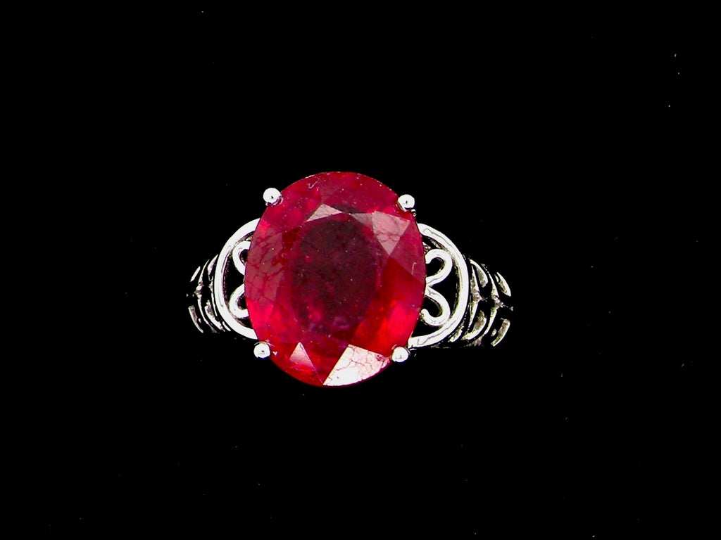 A single stone glass filled ruby  ring
