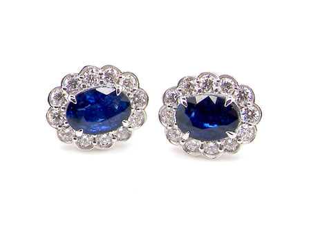 A pair of white gold sapphire and diamond cluster earrings