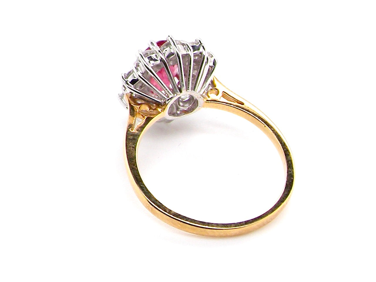 rear A classic cluster ring centred with an oval pinkish-red ruby measuring approximately 9 × 6 mm (estimated 1.75 carats)